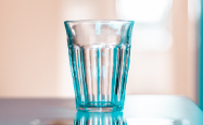 Transparent blue glass tumbler sitting on a table